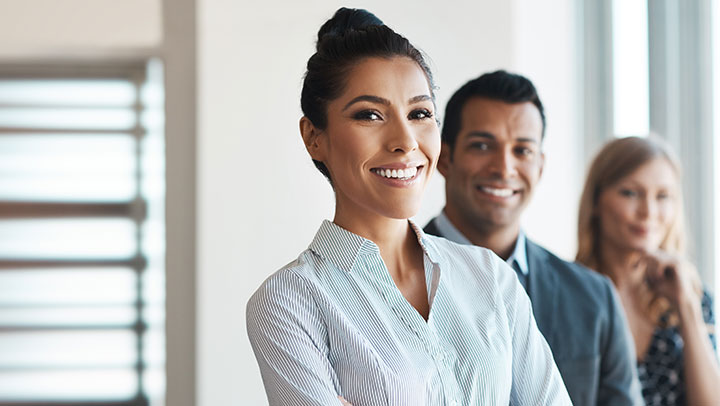 Image of a business woman with a man standing behind her
