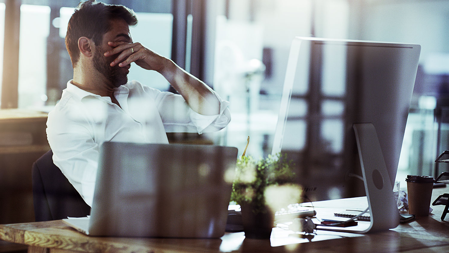 Image of a frustrated man with his hands over his eyes